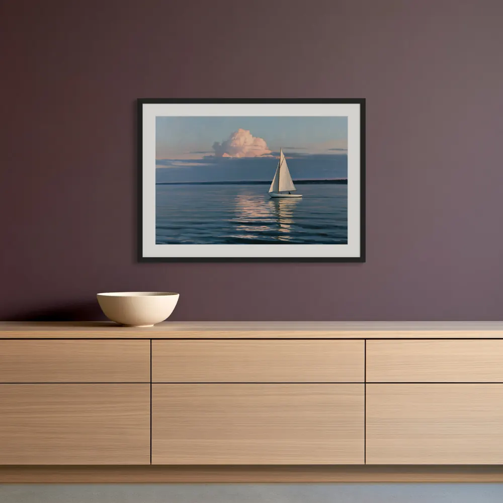 A sailboat-at-dusk oil painting as a black framed print with a white mat in the Aubergine wall and oak credenza