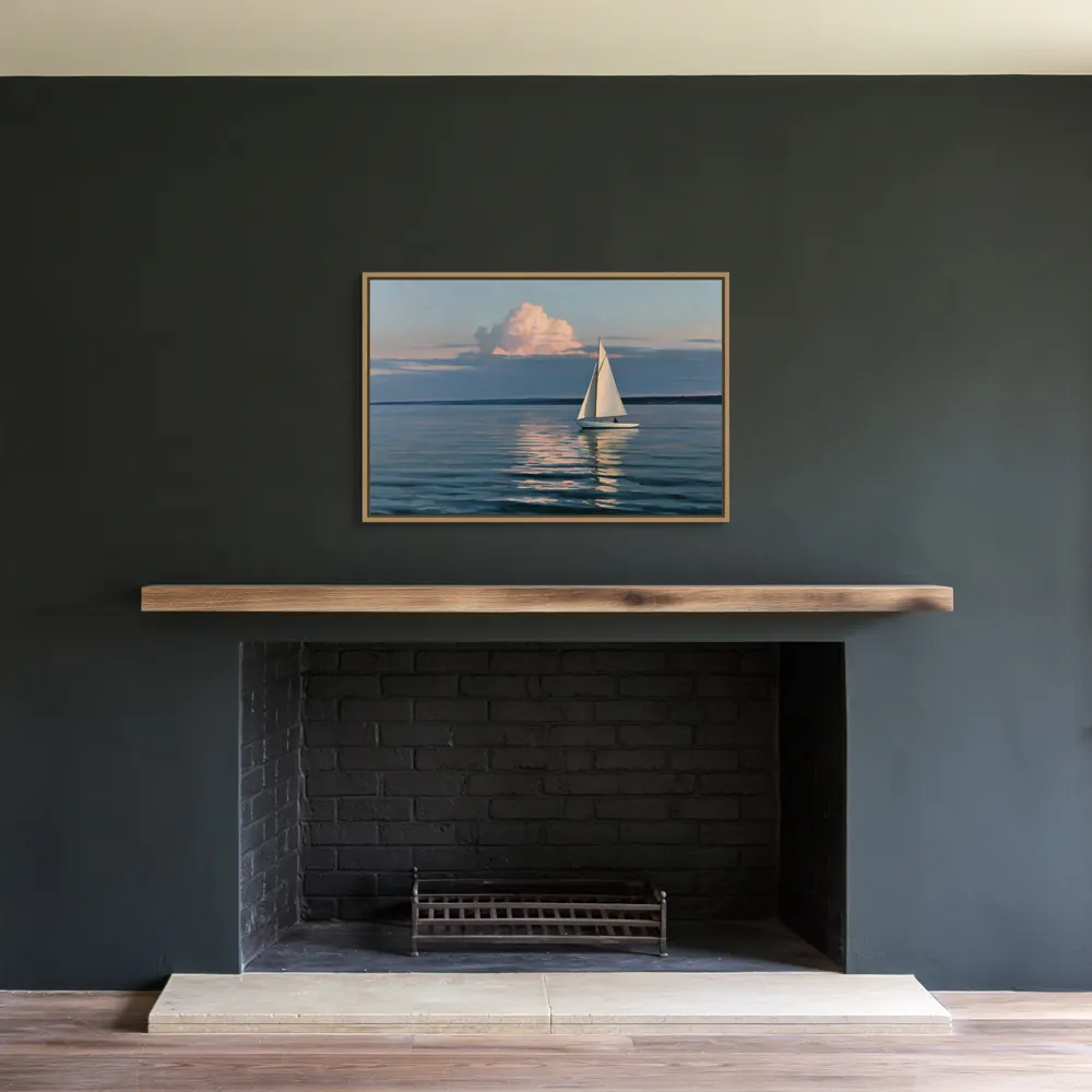 A sailboat-at-dusk oil painting as a natural oak floating-frame canvas in the Charcoal recessed fireplace