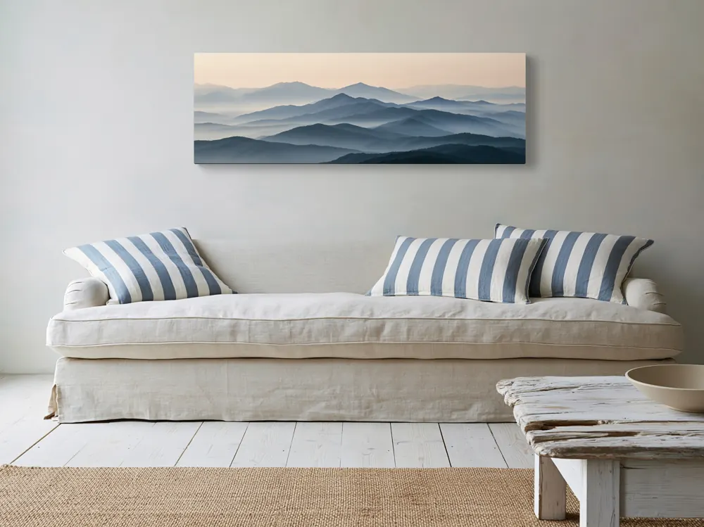 A misty mountain panorama as a stretched canvas in the Coastal living room with slipcovered sofa