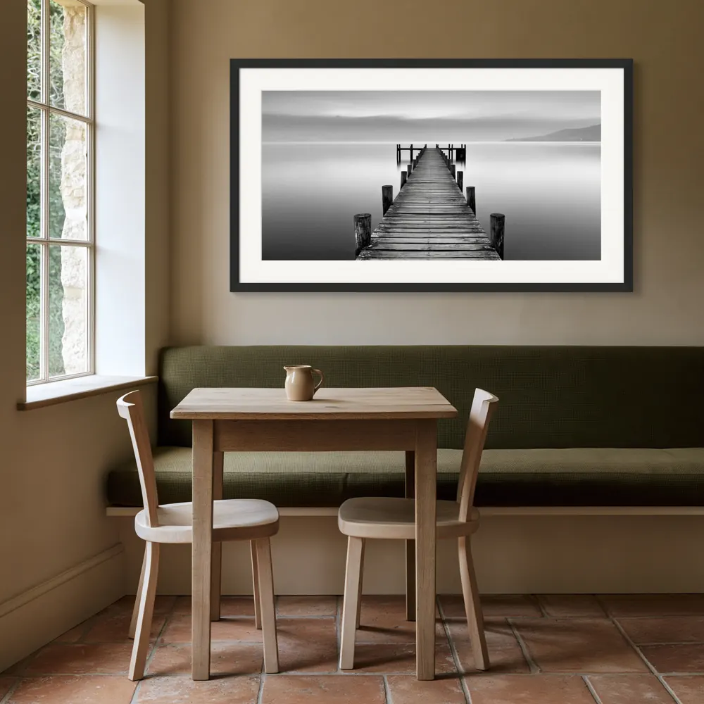 A black-and-white lake pier photograph as a black framed print with a white mat in the Country-house breakfast bay