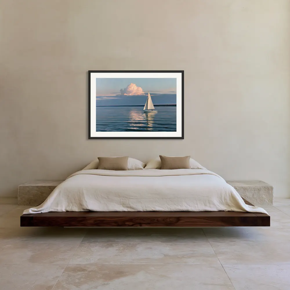 A sailboat-at-dusk oil painting as a black framed print with a white mat in the Desert walnut platform bedroom