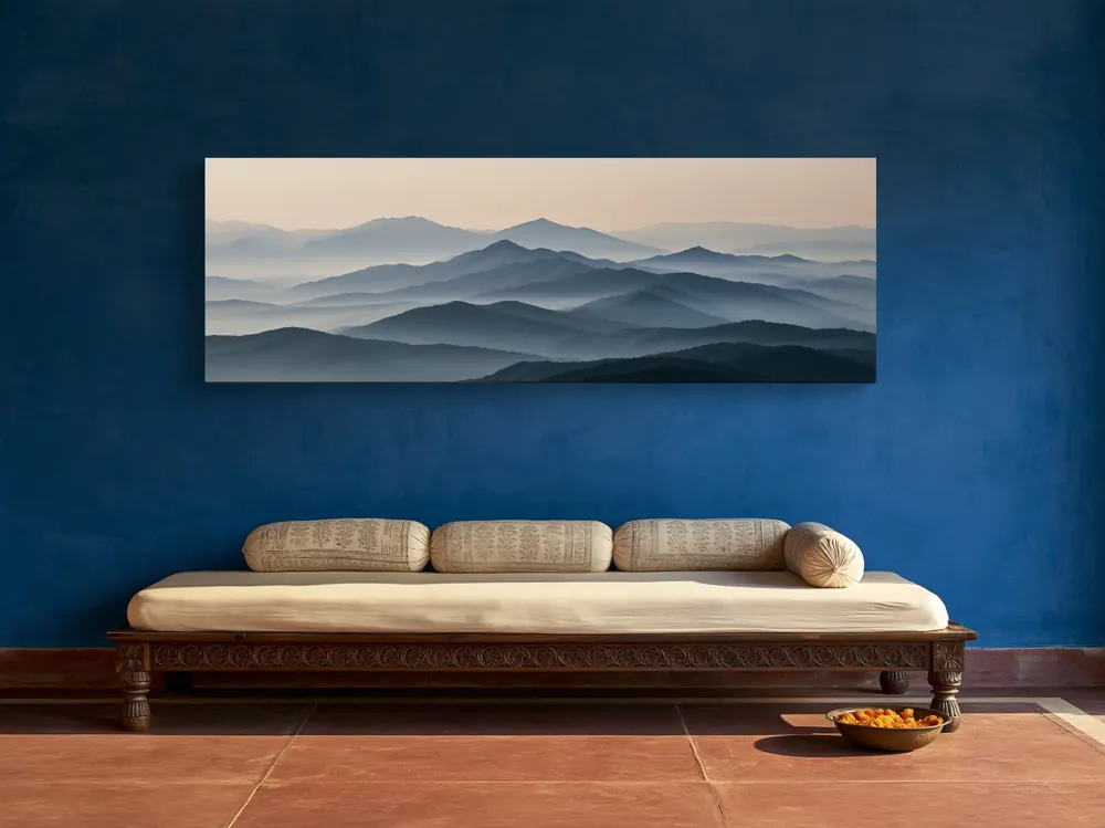 A misty mountain panorama as a stretched canvas in the Haveli verandah with a low carved diwan
