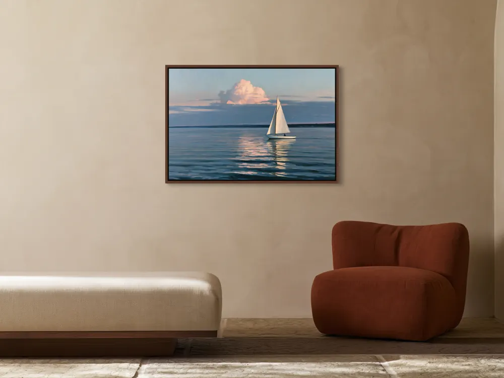 A sailboat-at-dusk oil painting as a walnut floating-frame canvas in the Ivory reception lounge