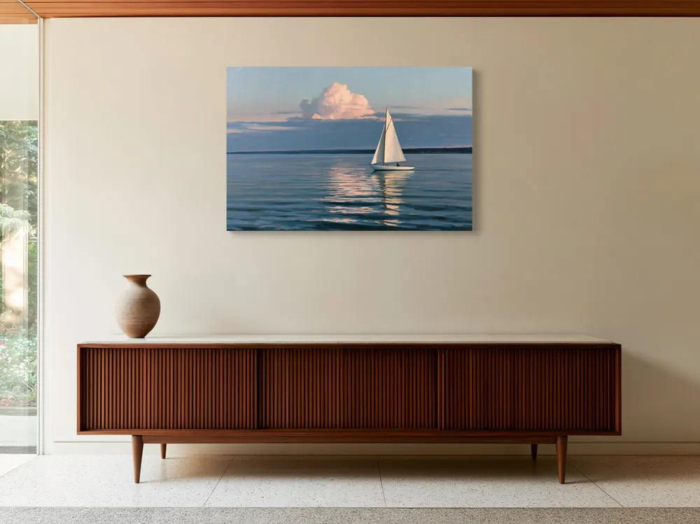 A sailboat-at-dusk oil painting as a stretched canvas in the Mid-century modernist house credenza