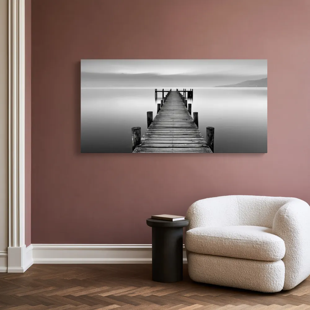 A black-and-white lake pier photograph as a stretched canvas in the Rose reading alcove
