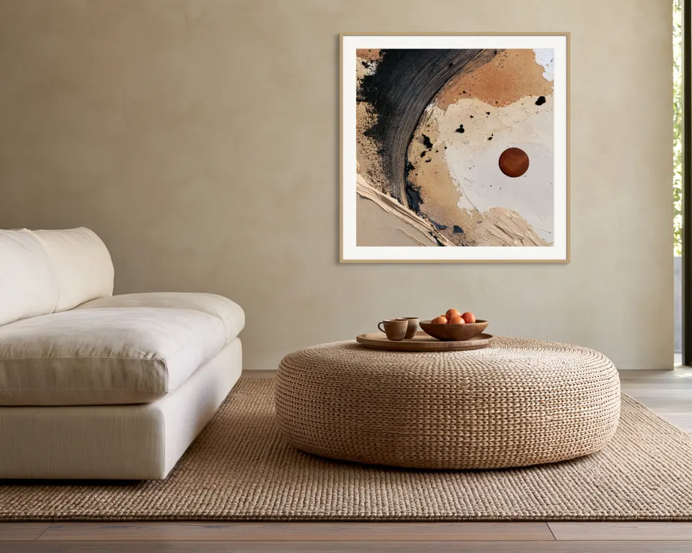 A textured neutral abstract as a natural oak framed print with a white mat in the Woven ottoman lounge